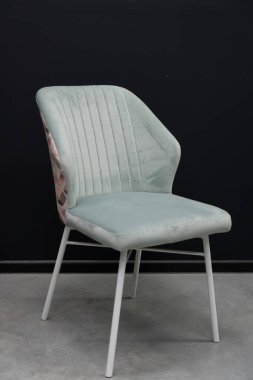 Çiçekli sırtı ve parlak metal bacakları olan zarif, yeşil kadife bir yemek sandalyesi modern konfor ve sofistike bir ortam sunuyor. Ev dekorasyonu için ideal.