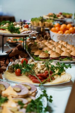 Şişe, taze meyve, peynir ve çeşitli parti yemekleri üzerine mini burgerler dahil nefis aperatifler sergilenen müsrif bir açık büfe. Etkinlikler için mükemmel.