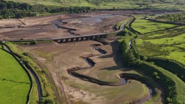Büyük Manchester 'a içme suyu sağlayan sistemin bir parçası olan rezervuar, kuraklık şartları sırasında belirgin derecede düşük olan Woodhead rezervuarının havadan görünüşü, Haziran 2025' te Kuzey Derbyshire 'da yer almaktadır.