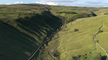 Kettlewell, Yukarı Wharfedale, Yorkshire Dales, İngiltere 'de dolambaçlı bir akarsu ile Sersemletici Yeşil Vadi Panoramik Drone Manzarası.
