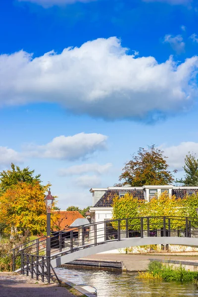 stock image Bridge over the central canal of historic village Kollum, Netherlands