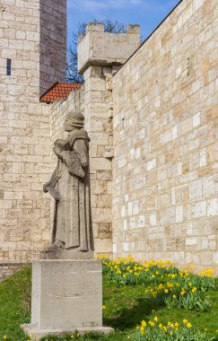 Statue of Thomas Muntzer at the city walls in Muhlhausen, Germany clipart