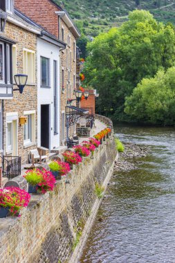 Flowers on the quay in the historic center of La Roche-en-Ardenne, Belgium clipart