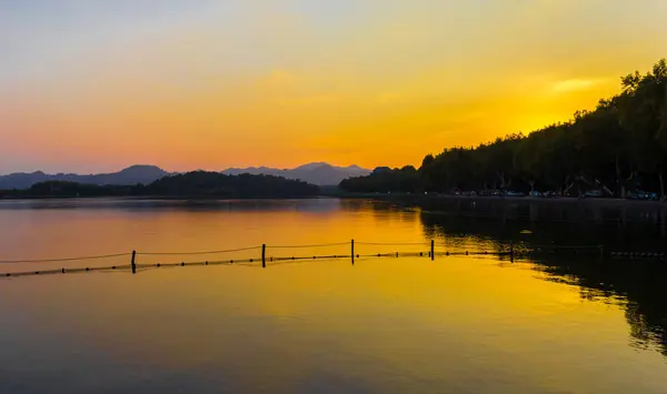 stock image Sunset over the mountains at the West lake in Hangzhou, China