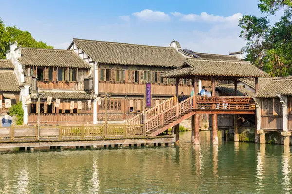 stock image Wooden houses and bridge at the lake in Wuzhen, China