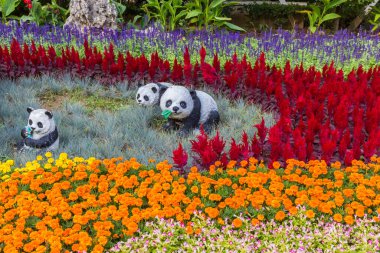 Panda sculpture in a flowerbed in the Renmin peoples park of Tianjin, China clipart