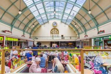 People at a cafe in the historic Grainger Market of Newcastle upon Tyne, England clipart