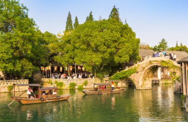 Wooden boats and the Renji bridge in Wuzhen, China clipart