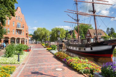 Flowers in front of the historic ship in Papenburg, Germany clipart