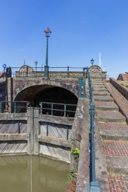 Steps going up the historic lock in Termunterzijl, Netherlands clipart