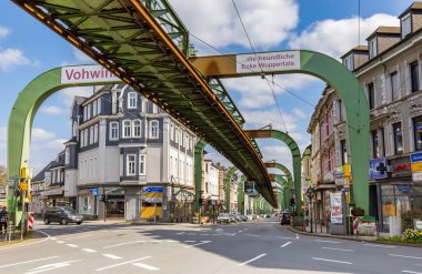 Historic Schwebebahn train going over an intersection in Vohwinkel Wuppertal, Germany clipart