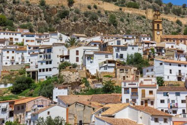 White houses and church tower on the hill in small village Chulilla, Spain clipart