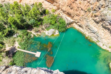 Aerial view over the turquoise lake (Charco Azul) in Chulilla, Spain clipart