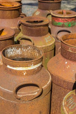 Old historic rusty milk canisters in Orvelte, Netherlands clipart