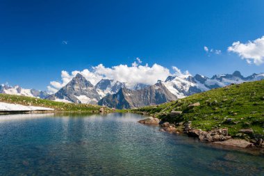 A wonderful view of the Caucasus Mountains with a lake in the foreground