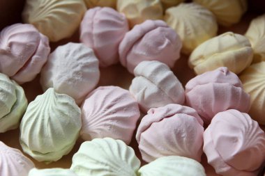 Marshmallow production. Fresh, sweet, multi-coloured marshmallows just cooked at a confectionery factory are sent for packing