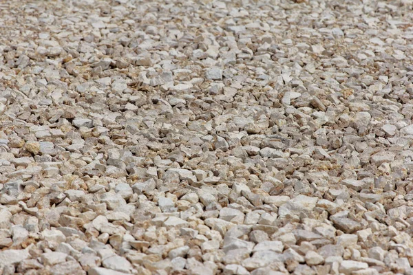 Gravel of large fractions Crushed stone building aggregate stone structure. Crushed Stone close-up Lies on ground. Breakstone. Granite gravel construction materials