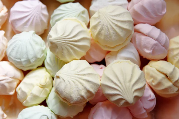 Marshmallow production. Fresh, sweet, multi-coloured marshmallows just cooked at a confectionery factory are sent for packing