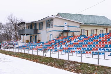 Review of sports stadium. Treadmill, sports complex and places for fans, outdoors in winter