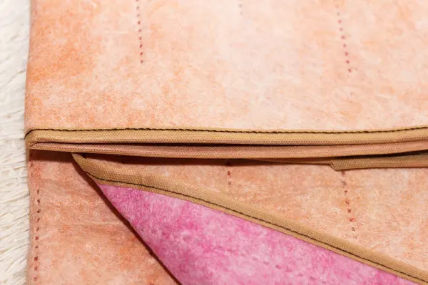 stock image Surface of a warm two-sided electro sheet, laid out on bed, looks from top. This is a quick and economical way to heat up in cold season, in winter