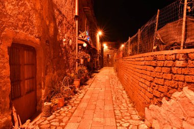 A narrow street among the old stone houses of a medieval quarter of the city of Caserta, Italy. clipart