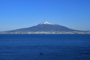The Vesuvius volcano stands out over the gulf of Naples. Landscape from the town of Vico Equense, Italy. clipart