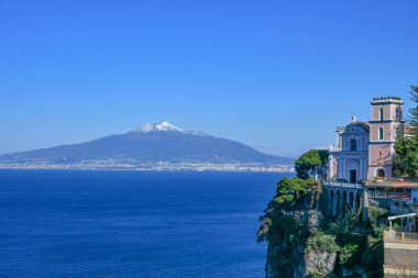 The Vesuvius volcano stands out over the gulf of Naples. Landscape from the town of Vico Equense, Italy. clipart