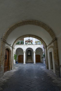 Entrance in the courtyard of a noble palace located in Lucera, an ancient Apulian town in the province of Foggia, Italy..