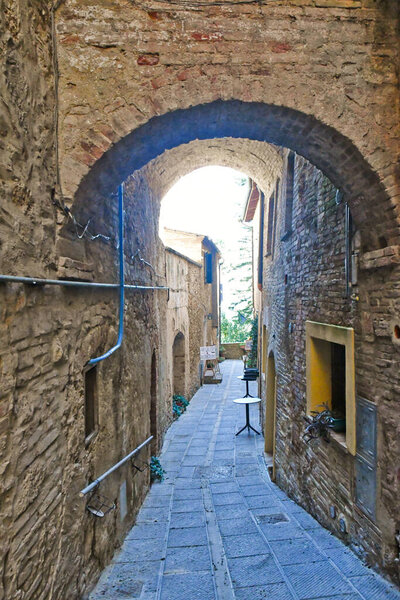 A street between the houses of Montepulcianoa medieval village in Tuscany, Italy..