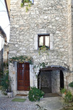 The facade of an old house in the medieval village of Pastena in Italy. clipart