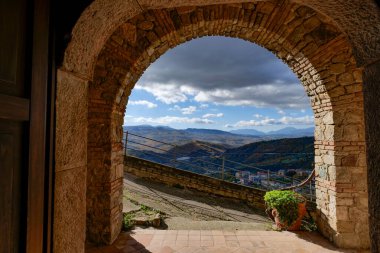 A stone arch overlooking the landscape of Calitri, a town in Campania, Italy. clipart