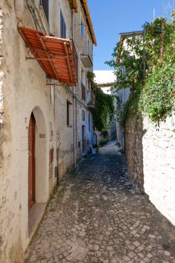 An alley among the stone houses of Maranola, a small medieval town in the municipality of Formia, Italy. clipart