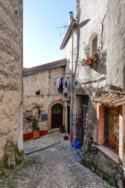 An alley among the stone houses of Maranola, a small medieval town in the municipality of Formia, Italy. clipart