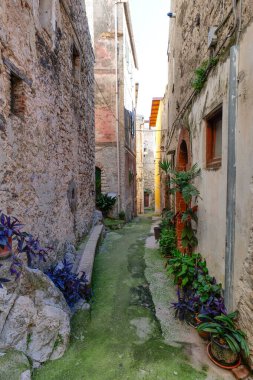 An alley among the stone houses of Maranola, a small medieval town in the municipality of Formia, Italy. clipart