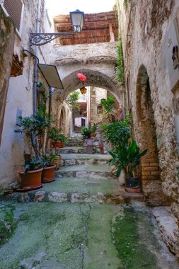 An alley among the stone houses of Maranola, a small medieval town in the municipality of Formia, Italy. clipart