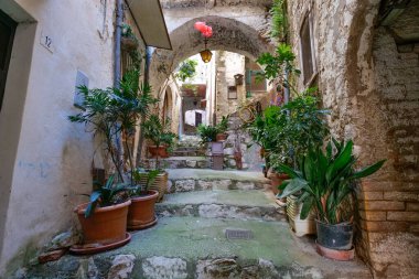 An alley among the stone houses of Maranola, a small medieval town in the municipality of Formia, Italy. clipart