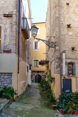 An alley among the stone houses of Maranola, a small medieval town in the municipality of Formia, Italy. clipart