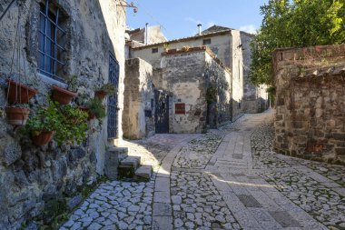 A narrow street between the houses of old Caserta, a medieval village in Italy. clipart