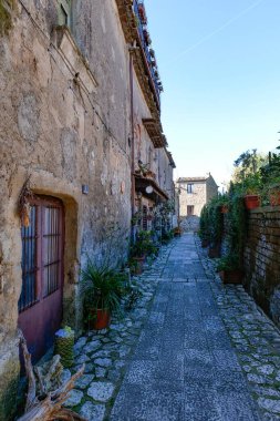 A narrow street between the houses of old Caserta, a medieval village in Italy. clipart