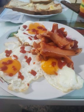 Yağda yumurta ve ızgara sosisle nefis bir kahvaltı.