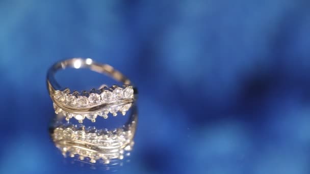Bague Blanc Sertie Diamants Photographiés Sur Bleu — Video