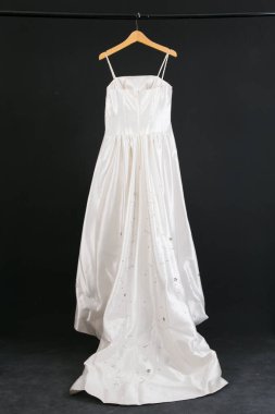 Siyah arka planda asılı gelinlik