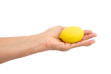 Kadın eli, beyaz arka planda stres topu sıkıyor.