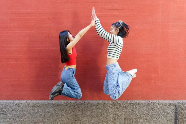 Full Body Side View Cheerful Young Asian Women Friends Jumping — Stock Photo, Image