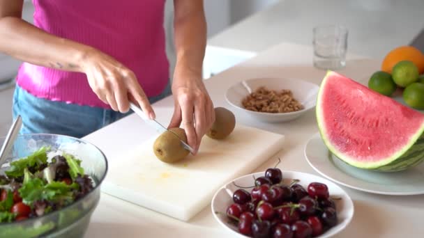 Slow Motion Crop Female Chopping Kiwi Board Table Salad Cherries — Stock Video