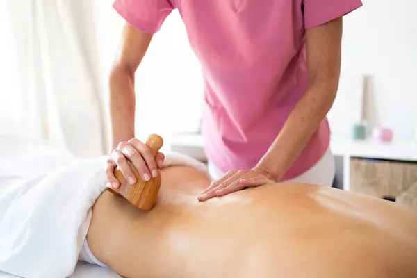 Crop Therapist Massaging Back Customer Lying Massage Table Wood Therapy — Stock Photo, Image