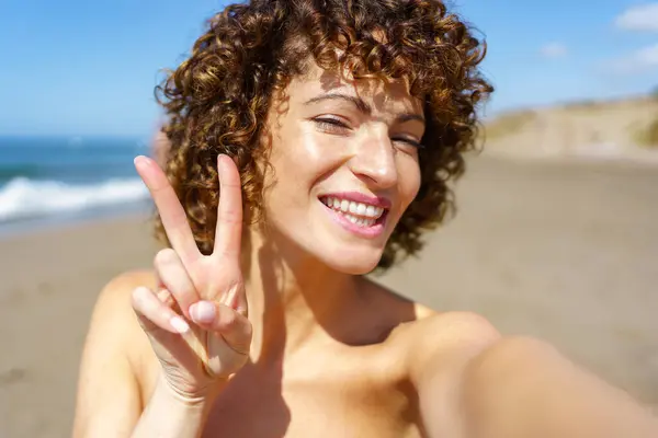Cheerful Young Female Curly Hair Smiling Looking Camera While Showing Stock Photo