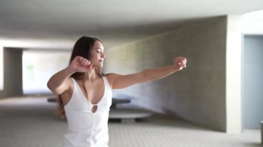 Kendine güvenen ve kendine güvenen bir kadın zarif, modern bir mimari mekanda poz verir. Görkemli zarafetini ve sunumunun her alanında kendine özgü tarzını sergiler.