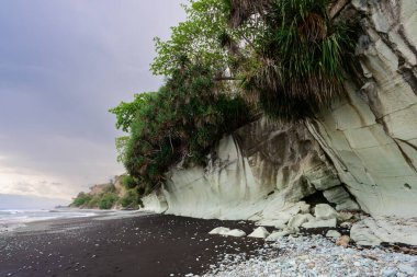 Penggajava Beach with Black Sand and Green Pebbles on Flores Island, Indonesia clipart