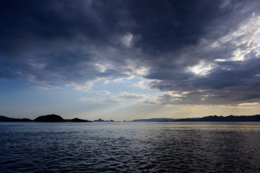 Komodo National Park Seascape with Dramatic Sky and Light Rays in Flores, Indonesia clipart